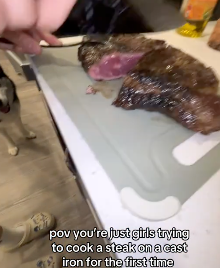 cutting into a raw steak